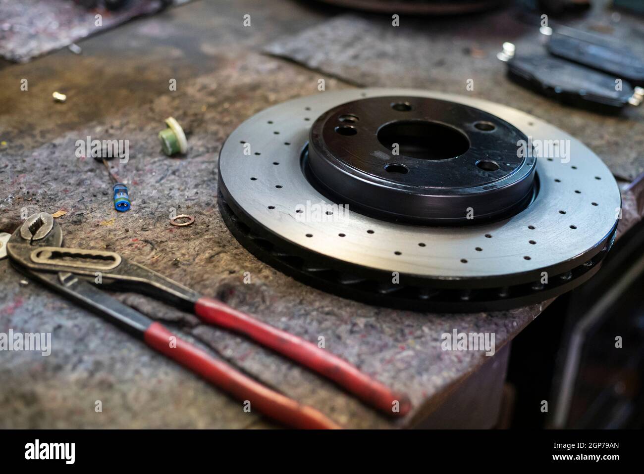 Detail of a perforated sports car disc brake, sport tuning spare parts Stock Photo