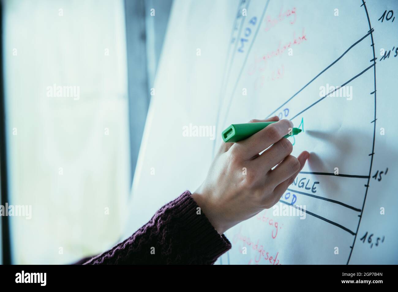 Woman drawing on a clipboard, workshop Stock Photo