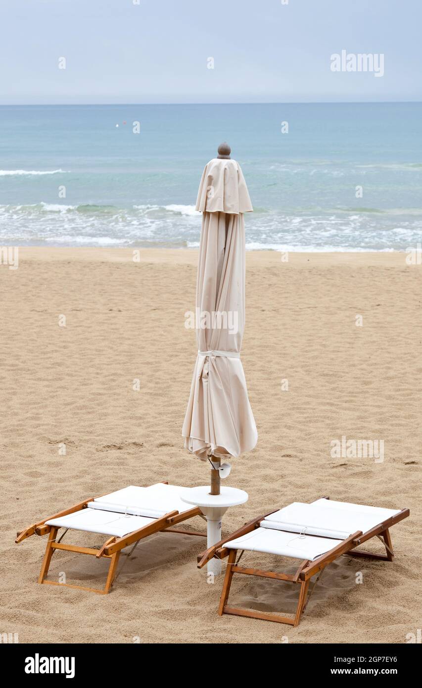Bathhouse empty with umbrellas closed because of bad weather Stock