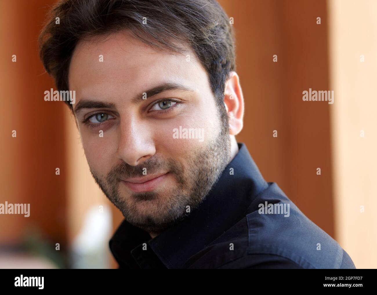Portrait of a handsome young man with green eyes Stock Photo - Alamy