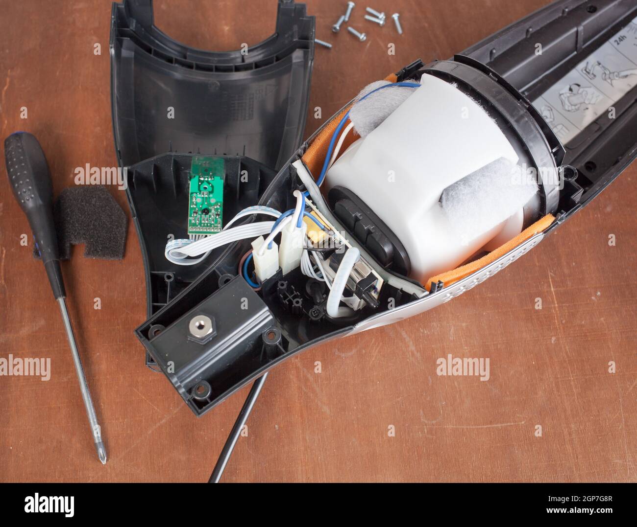 Vacuum cleaner disassembled for repair malfunctioning on work table