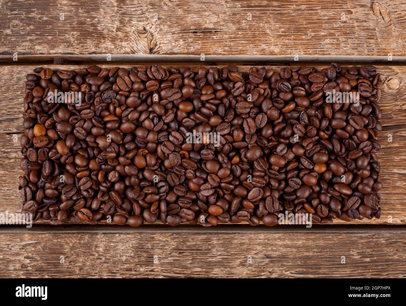 Rectangular shaped of coffee beans on wooden table Stock Photo