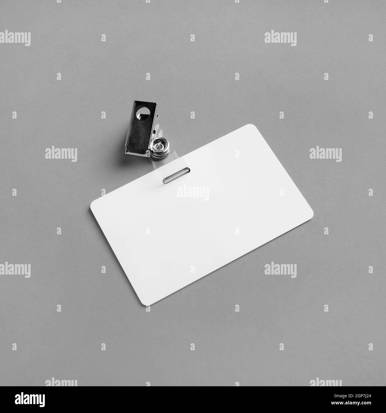 Blank plastic badge mockup on gray paper background. Empty ID mock up. Copy space for text. Blank template for for ID. Stock Photo