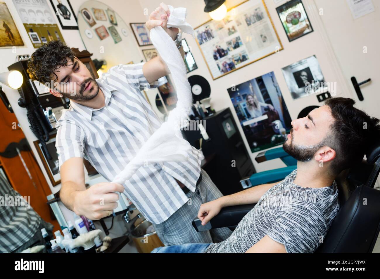 Traditional ritual of shaving the beard in a old style barber shop ...