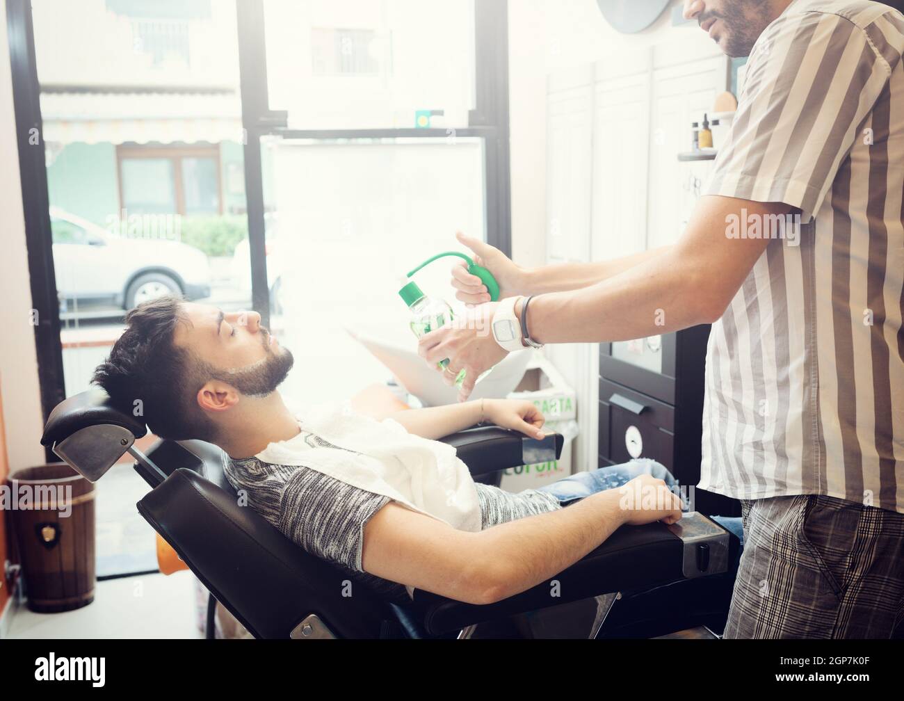 Traditional ritual of shaving the beard in a old style barber shop ...