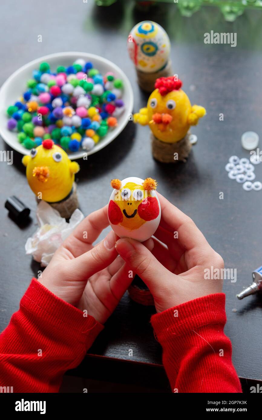 child-s-hands-hold-a-painted-egg-as-a-gift-to-celebrate-easter-stock
