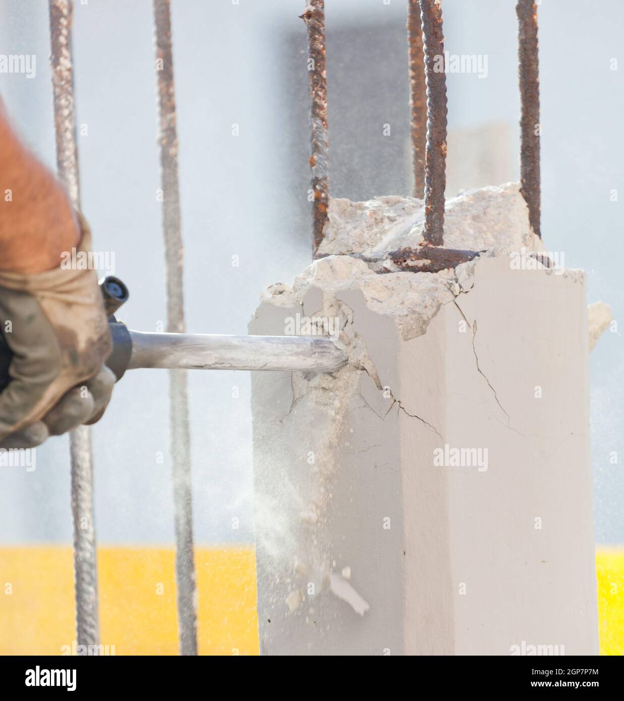 Workers break reinforced concrete with jackhammer at a construction site Stock Photo