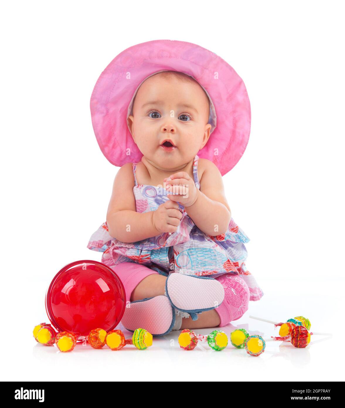 Portrait of cute female toddler with lollipop on white background Stock ...