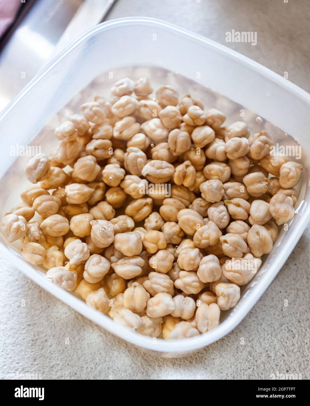 Chickpeas left in water to soak before cooking. Stock Photo