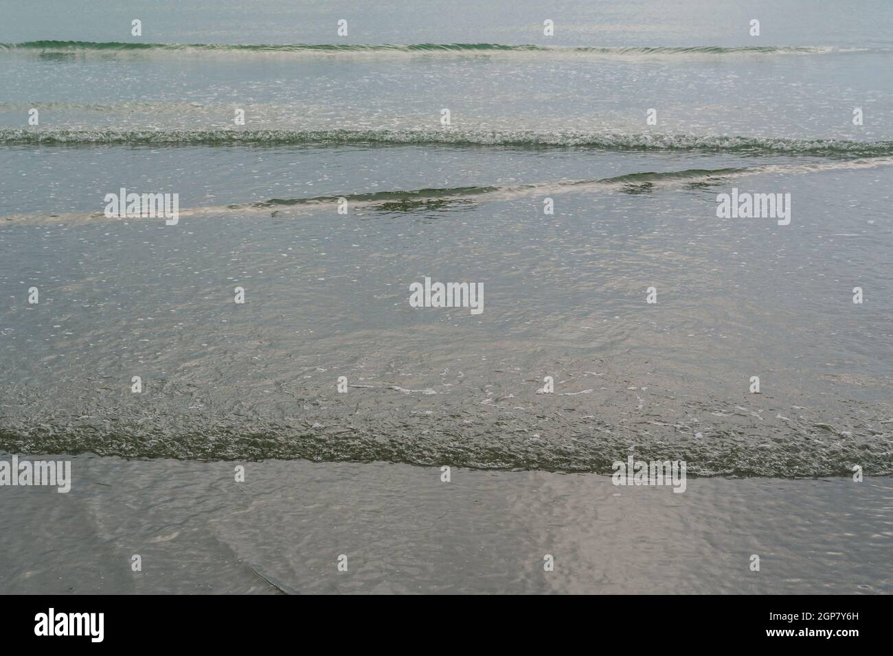 Ripples and small waves break at low tide Stock Photo