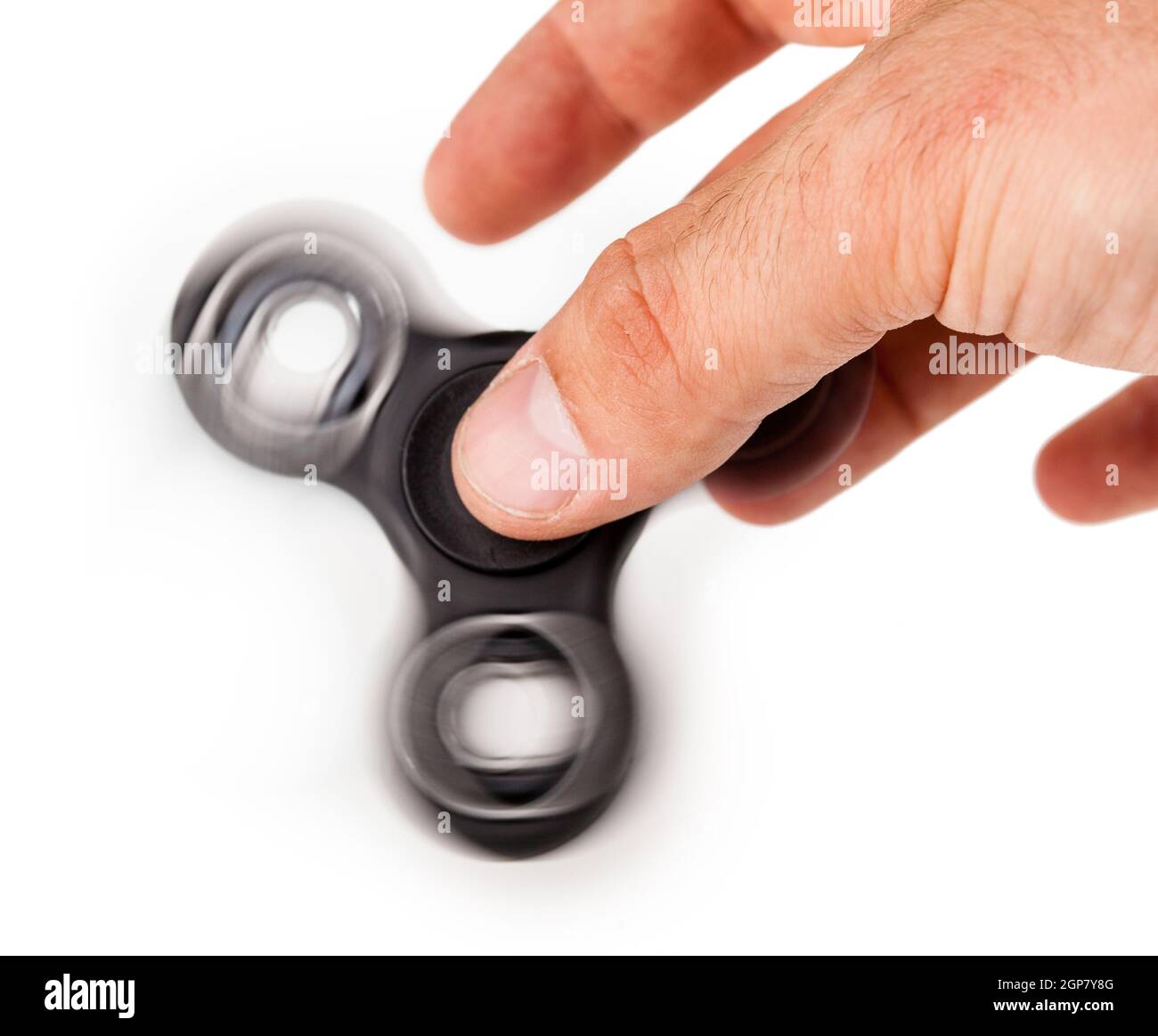 Palying with a Black Fidget Spinner isolated on white background Stock ...