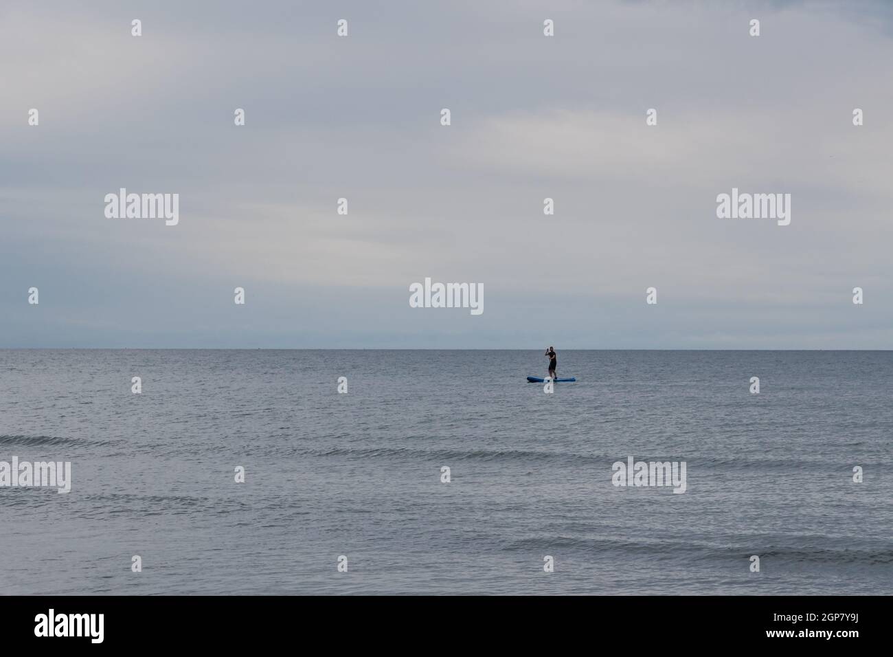A paddle boarder at sea Stock Photo