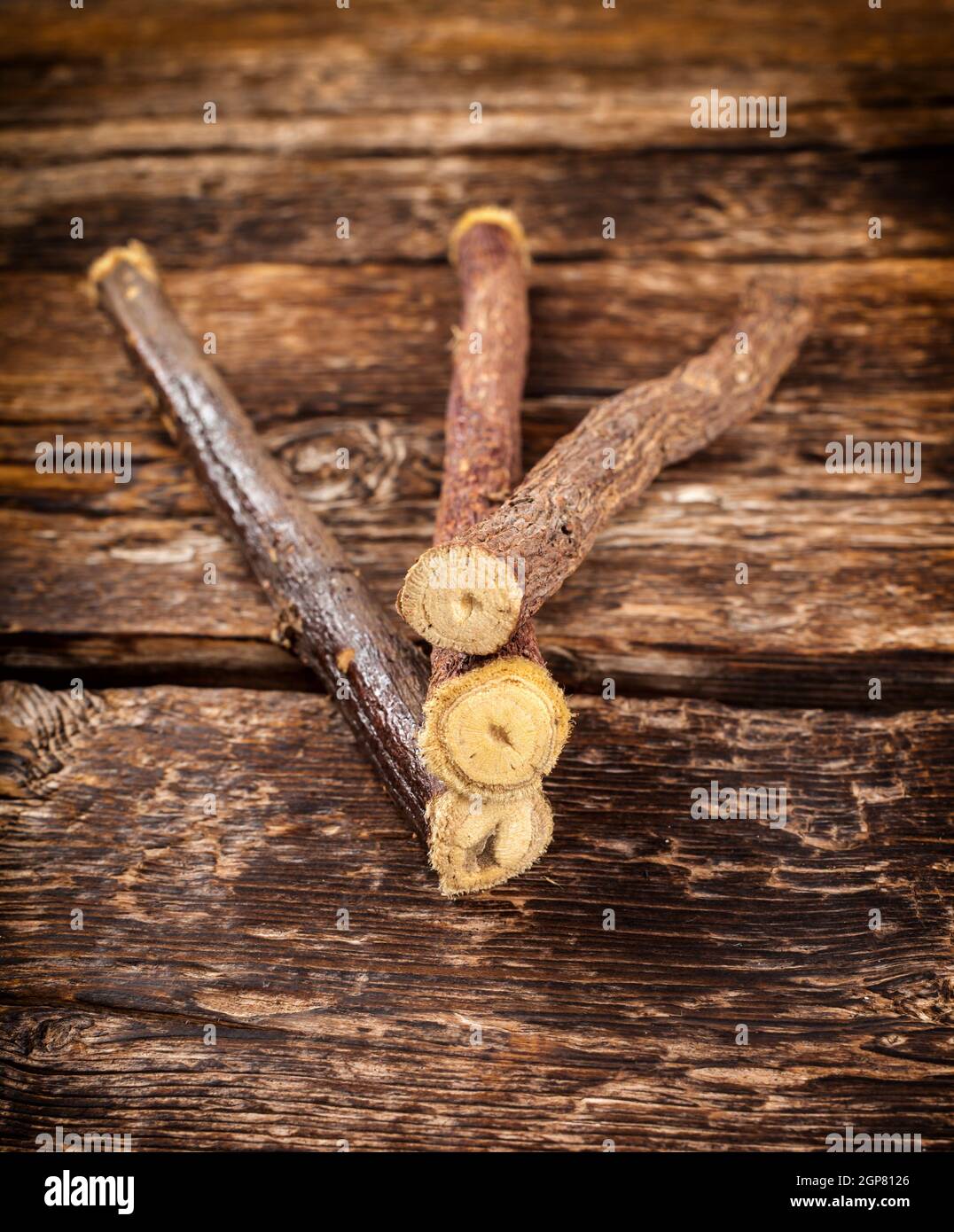 Close up of Licorice roots on wooden table. Stock Photo