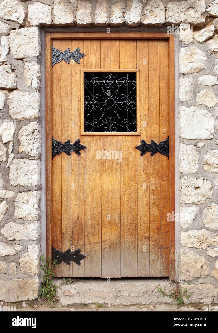Old wooden door in the stone wall Stock Photo - Alamy