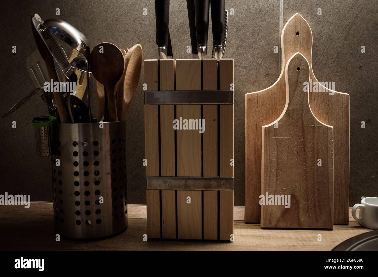 Kitchen accessories such as cutting board, knives and ladles under a