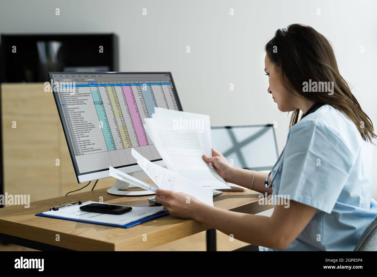 Medical Bill Codes And Spreadsheet Data. Business Analyst Woman Stock Photo