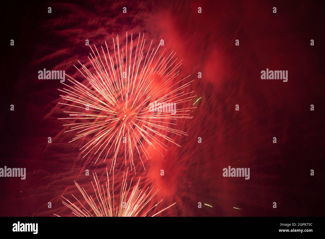 Salute in the sky. Explosion of fireworks in the night sky. Firecrackers flapping sparks in a dark space. Festive fireworks. Background with sparks fr Stock Photo