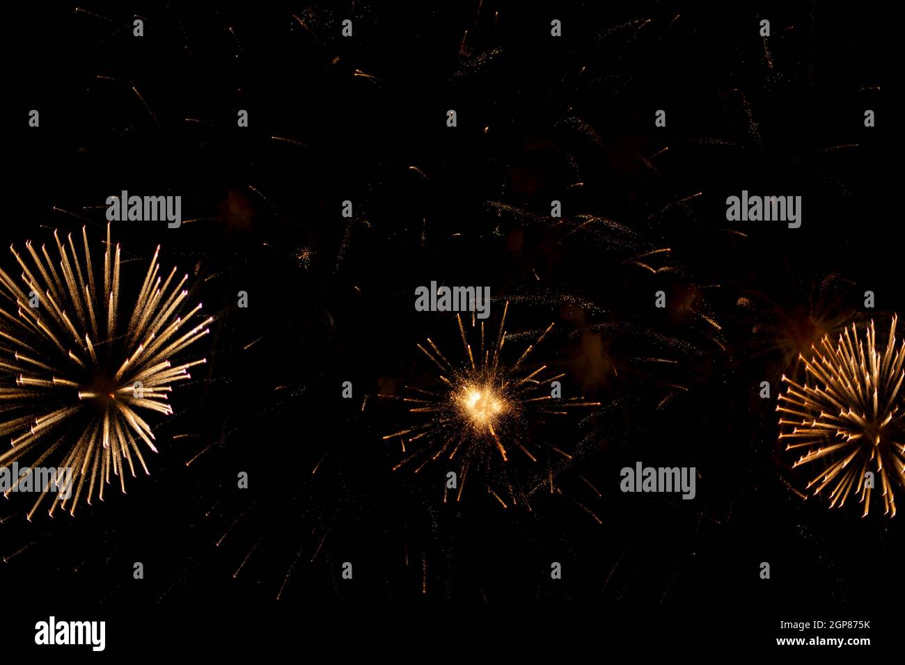 Salute in the sky. Explosion of fireworks in the night sky. Firecrackers flapping sparks in a dark space. Festive fireworks. Background with sparks fr Stock Photo