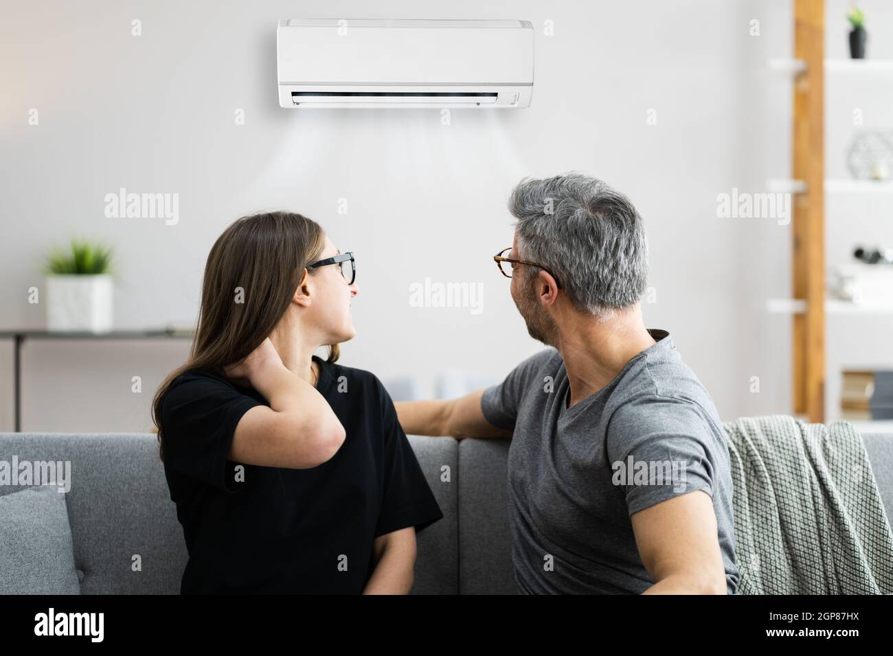 Air Conditioner Couple Sneezing And Having Sore Neck Stock Photo Alamy