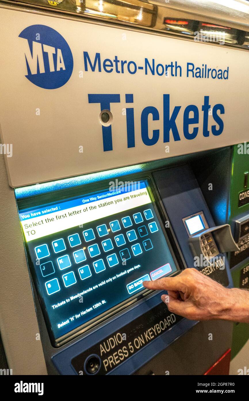 Man Purchasing Metro North Transit Train Tickets at Self Serve Vending Machine, Grand Central Terminal, NYC Stock Photo