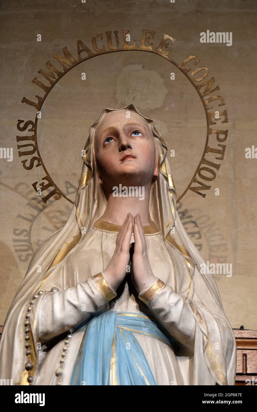 I Am the Immaculate Conception, Our Lady of Lourdes, statue in the St Francis Xavier's Church in Paris, France Stock Photo
