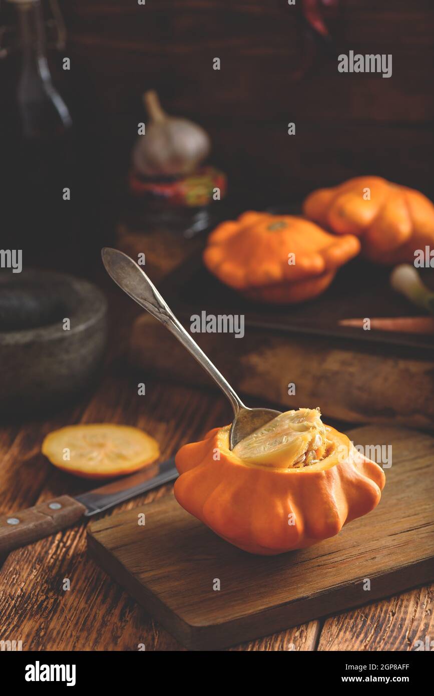 Preparing yellow pattypan squash for stuffing with minced meat Stock Photo
