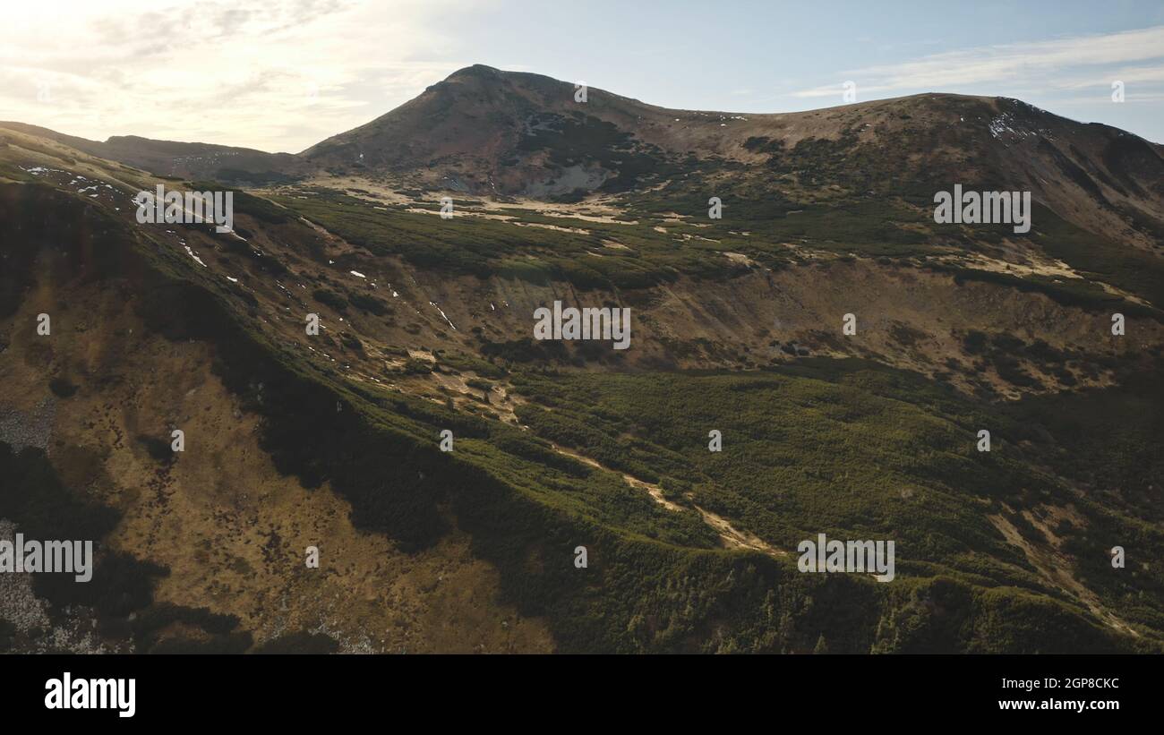 Close up mountain rock top aerial. Green grass, moss at hills, peak ...