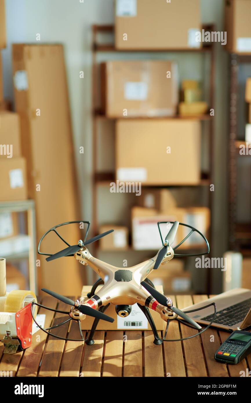 Delivery business. desk with parcels and drone in the warehouse Stock