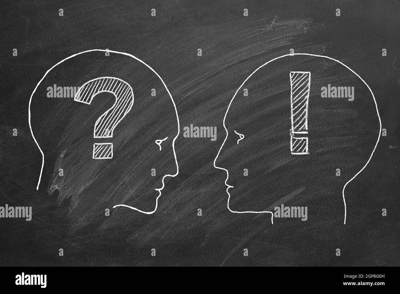 Chalk illustration on blackboard. Two male heads face to face with with question and exclamation marks inside. Answer to question. Debate concept. Con Stock Photo