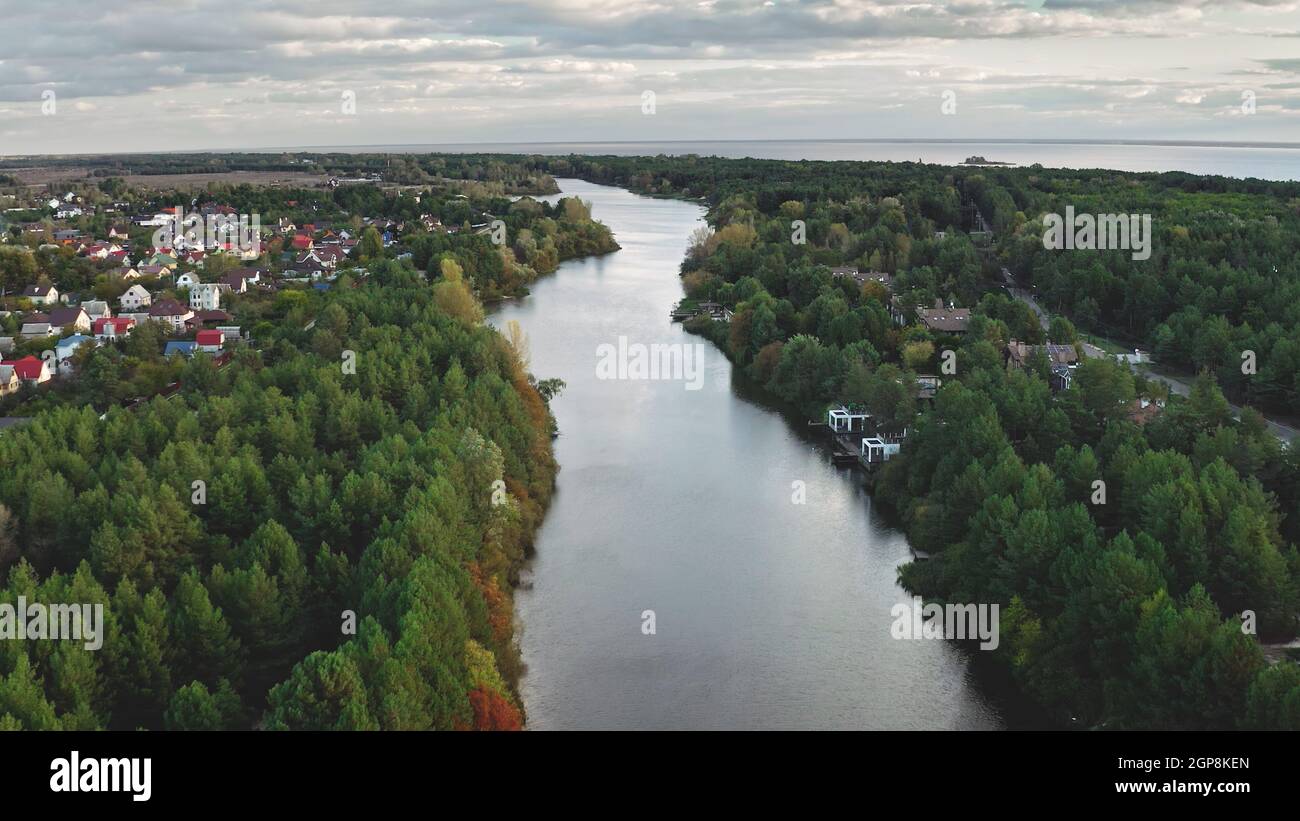 River at green leaf forest aerial. Nobody nature landscape. Autumn colorful park at urban streets. Cityscape with downtown buildings, cottages. Cinematic Dnieper, Kiev city, Ukraine, Europe Stock Photo