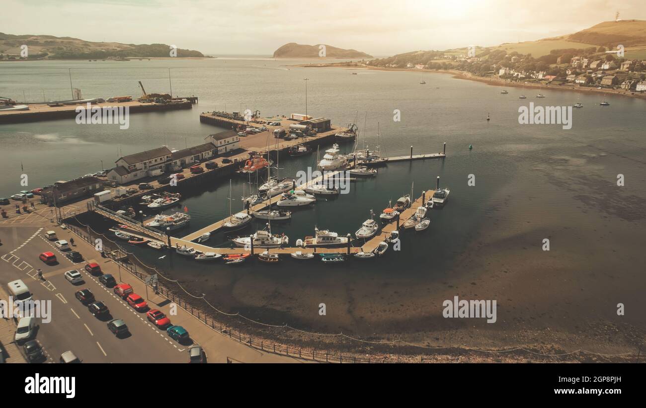 Seascape with yachts, ships on harbor. Aerial cityscape with modern buildings at downtown streets. Traffic road at dock aerial. People walk down of sea bay highway. Cars and vans drive on roadway Stock Photo