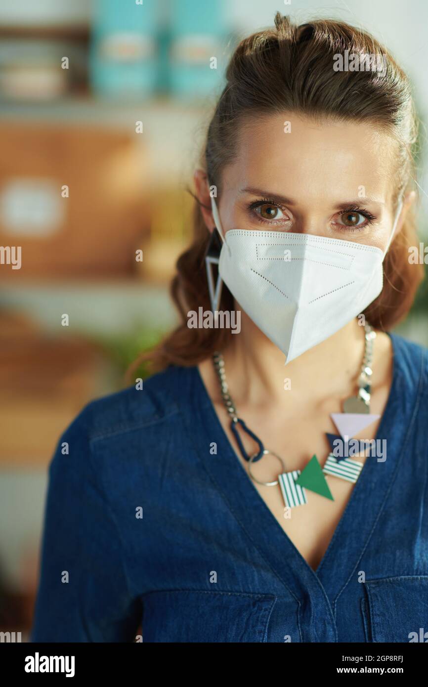Portrait of modern small business owner woman with ffp2 mask in the office. Stock Photo