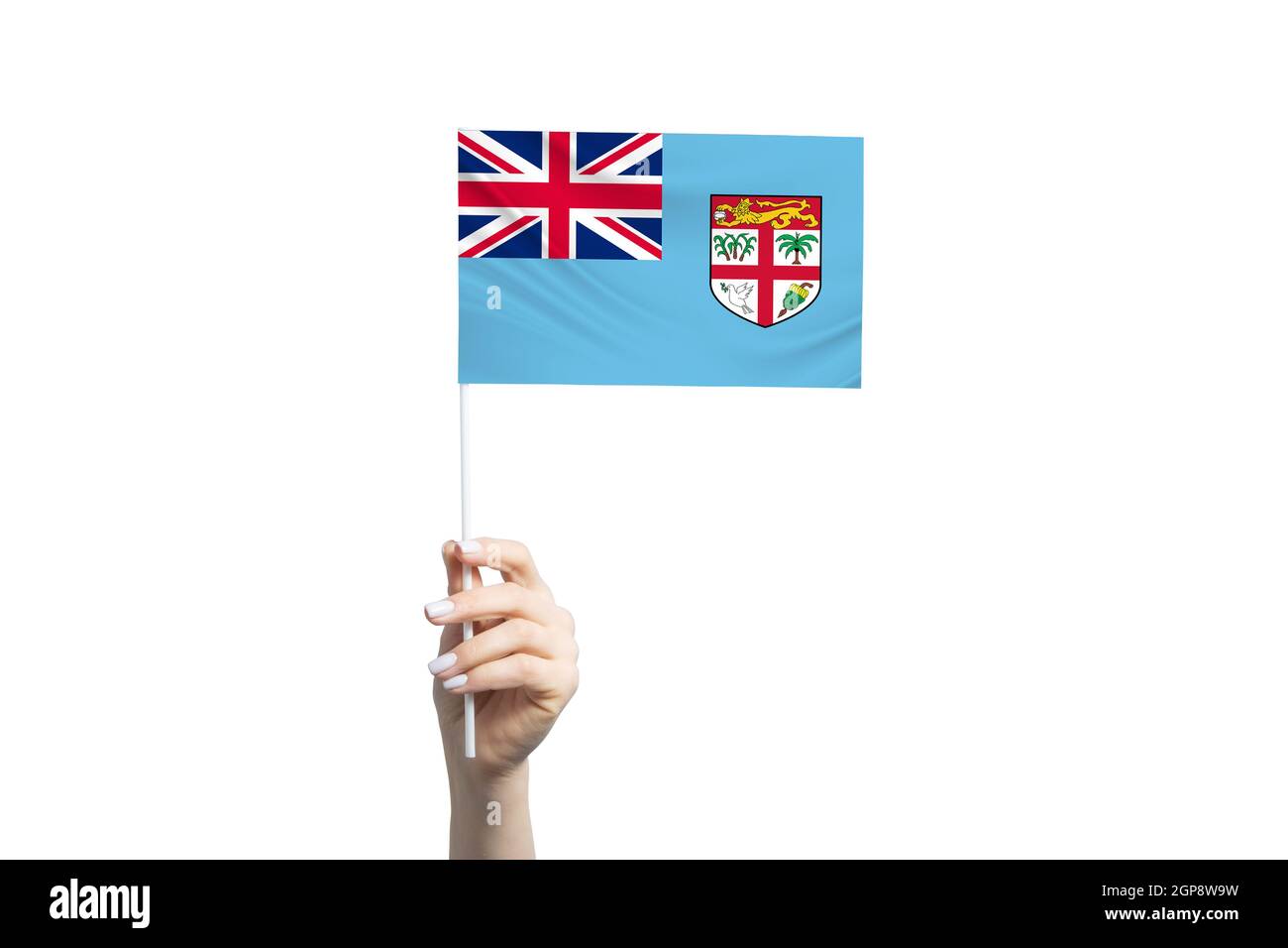 Beautiful female hand holding Fiji flag, isolated on white background. Stock Photo