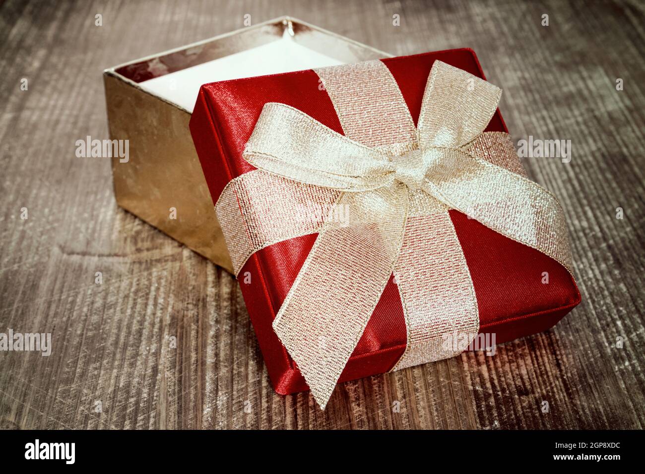 Open gift box with golden bow,close-up view Stock Photo - Alamy