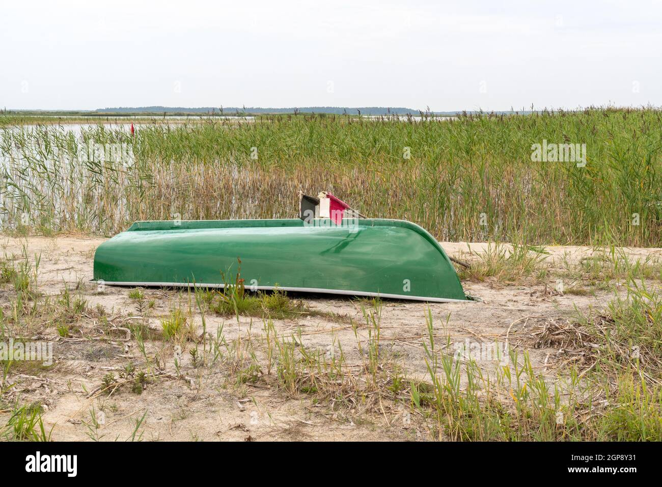 Fishing boat on the beach by the lake turned upside down Stock Photo
