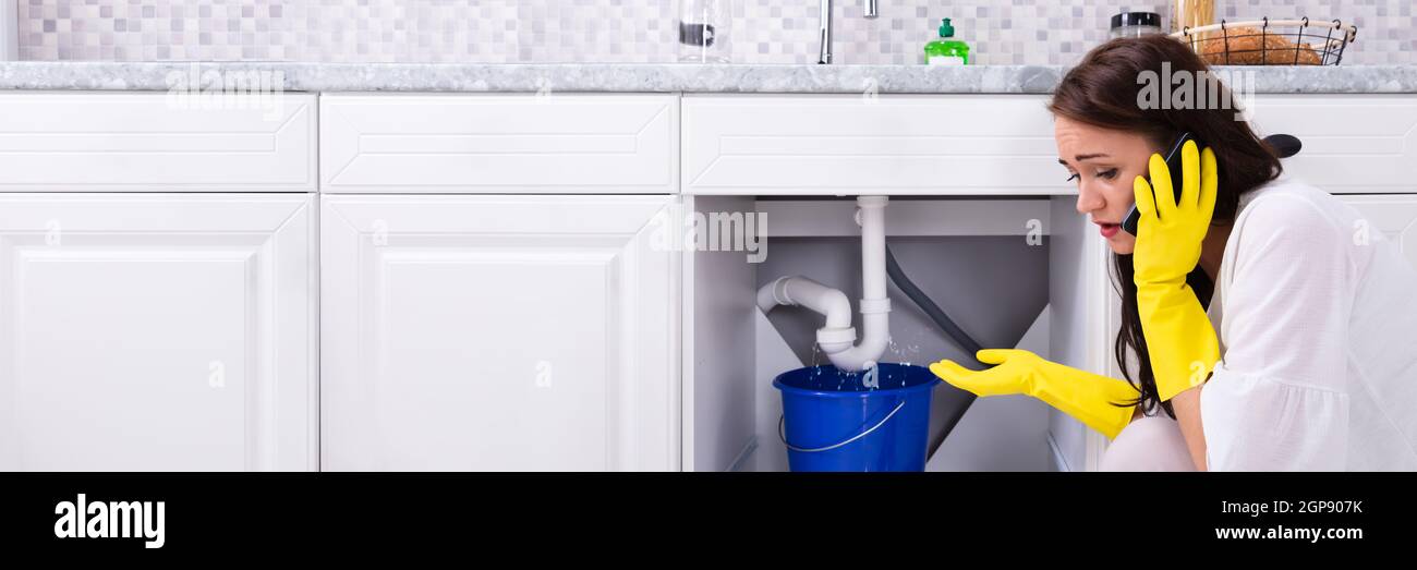 Pipe Water Leak In Kitchen Sink. Calling Plumber Stock Photo Alamy