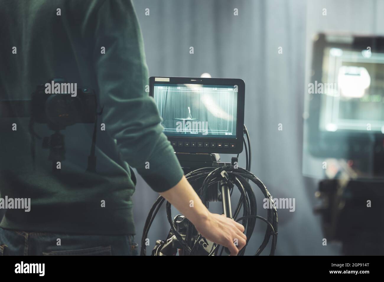 Male cameraman is operating a film camera in a television recording ...