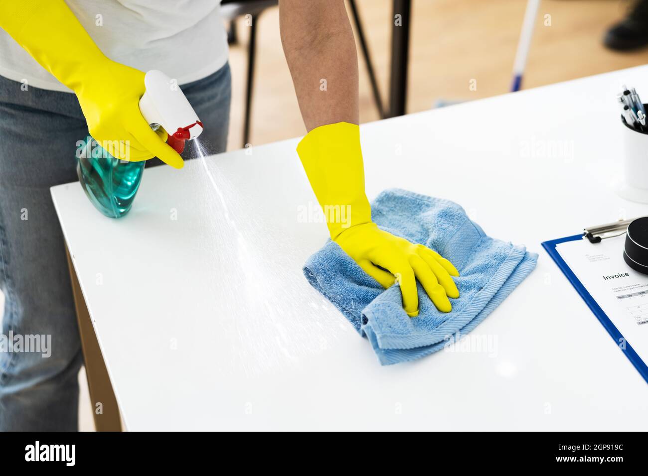 Janitor Cleaner Woman In Face Mask Cleaning Desk Stock Photo