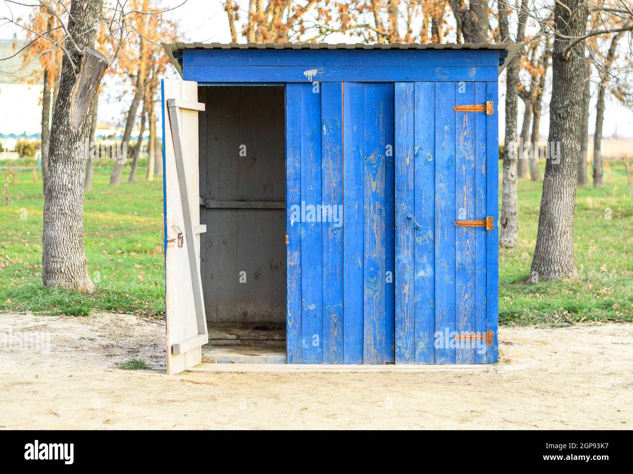 Public toilet in a street park. Blue wooden toilet, restroom Stock