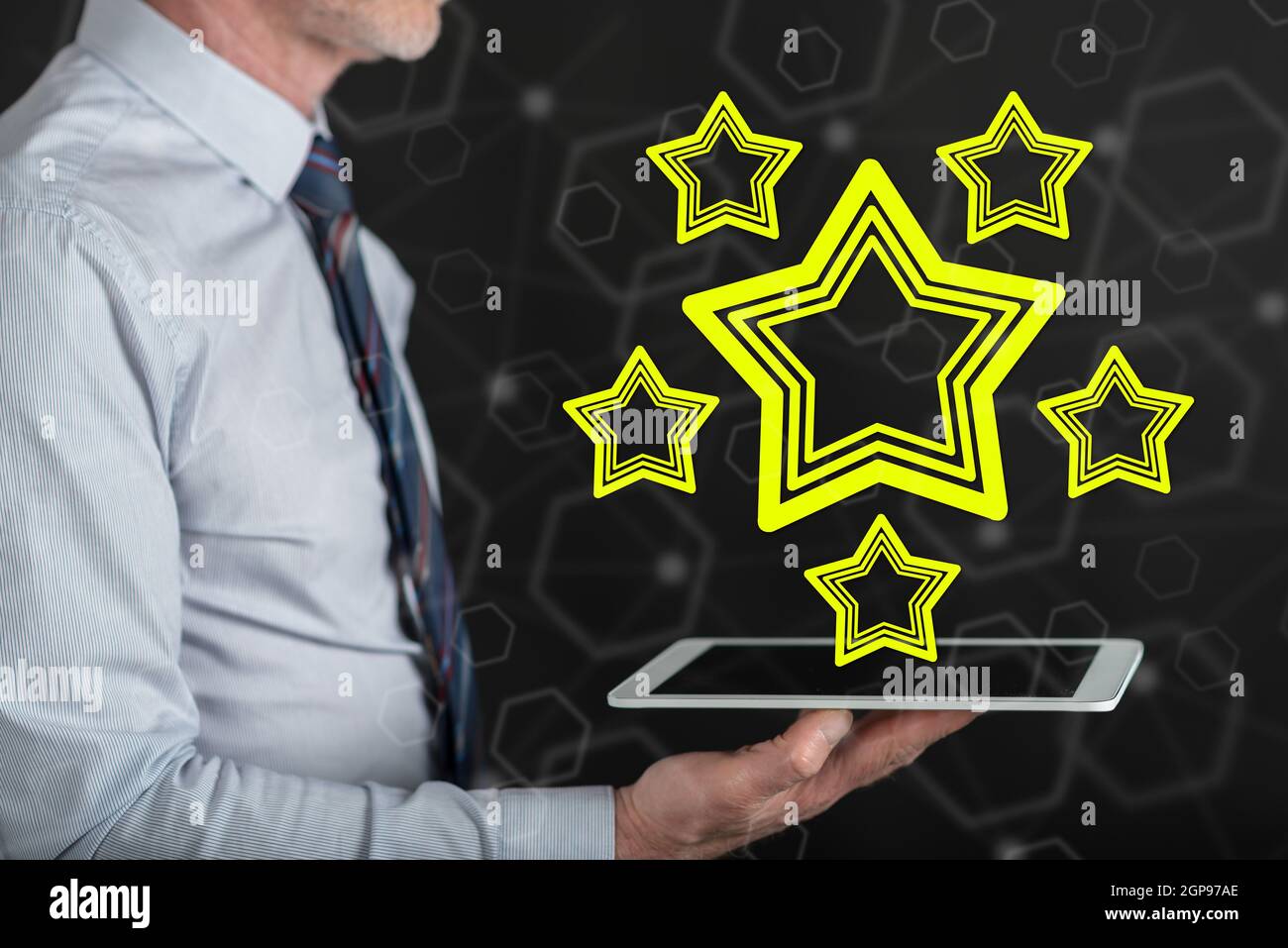 Quality concept above a tablet held by a man Stock Photo