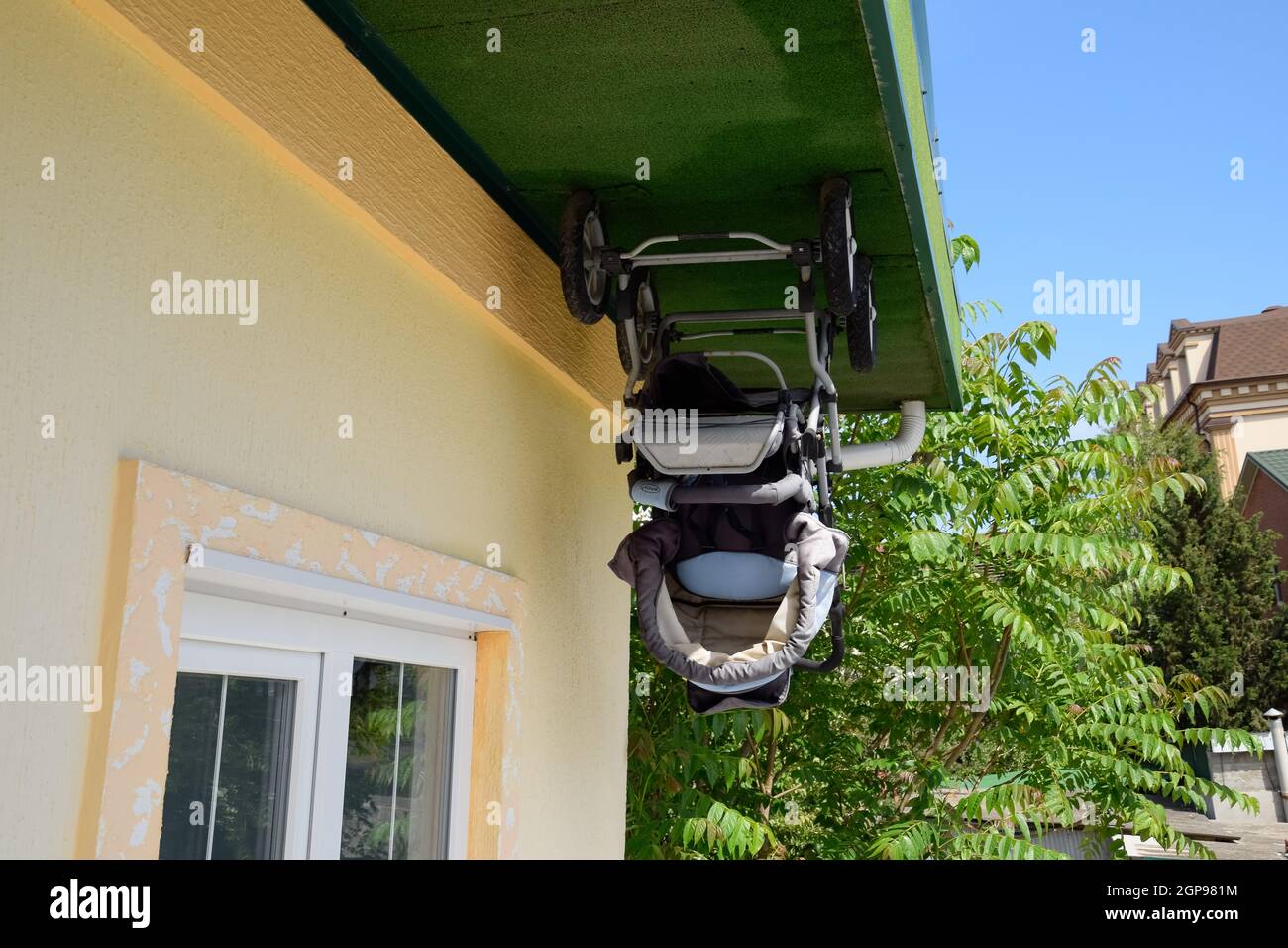 baby stroller in the house upside down. the house is the opposite. Stock Photo