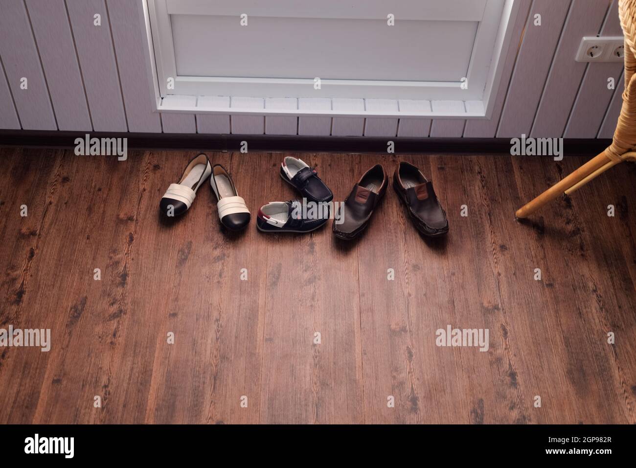 Shoes near the door in the hallway. Hallway in the house. Stock Photo