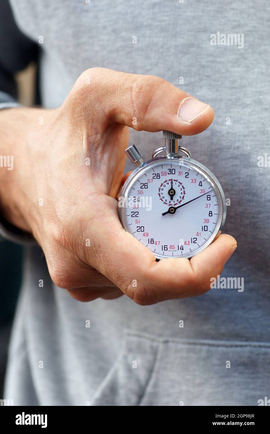 Coach measures time with stopwatch Stock Photo Alamy