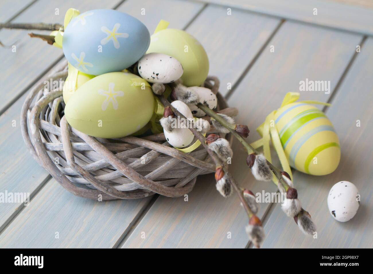 colorful easter eggs and branch in nest closeup Stock Photo - Alamy