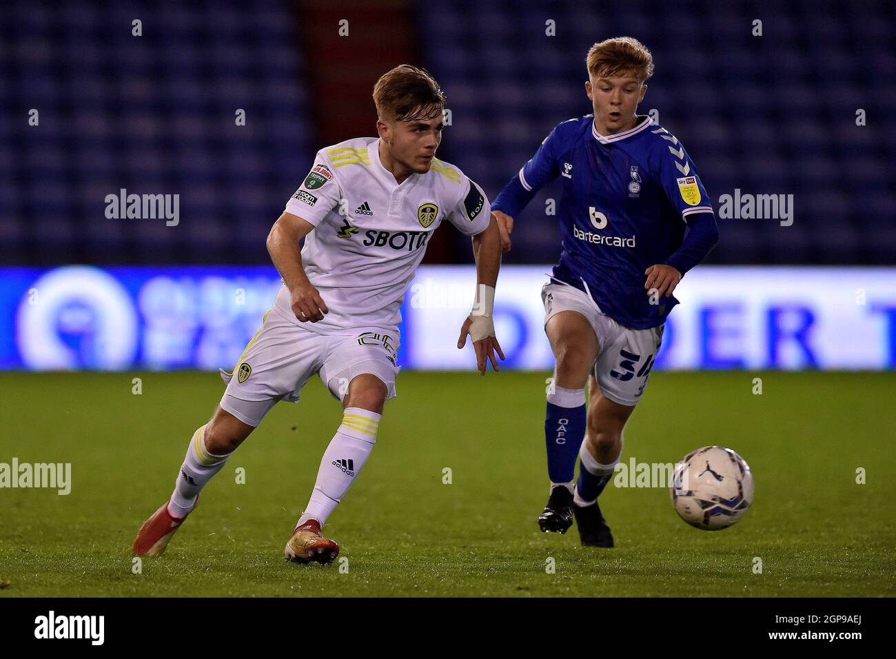 OLDHAM, UK. SEPT 28TH Lewis Bate of Leeds United and Oldham Athletic's Harry Vaughan during the EFL Trophy match between Oldham Athletic and Leeds United at Boundary Park, Oldham on Tuesday 28th September 2021. (Credit: Eddie Garvey | MI News) Credit: MI News & Sport /Alamy Live News Stock Photo