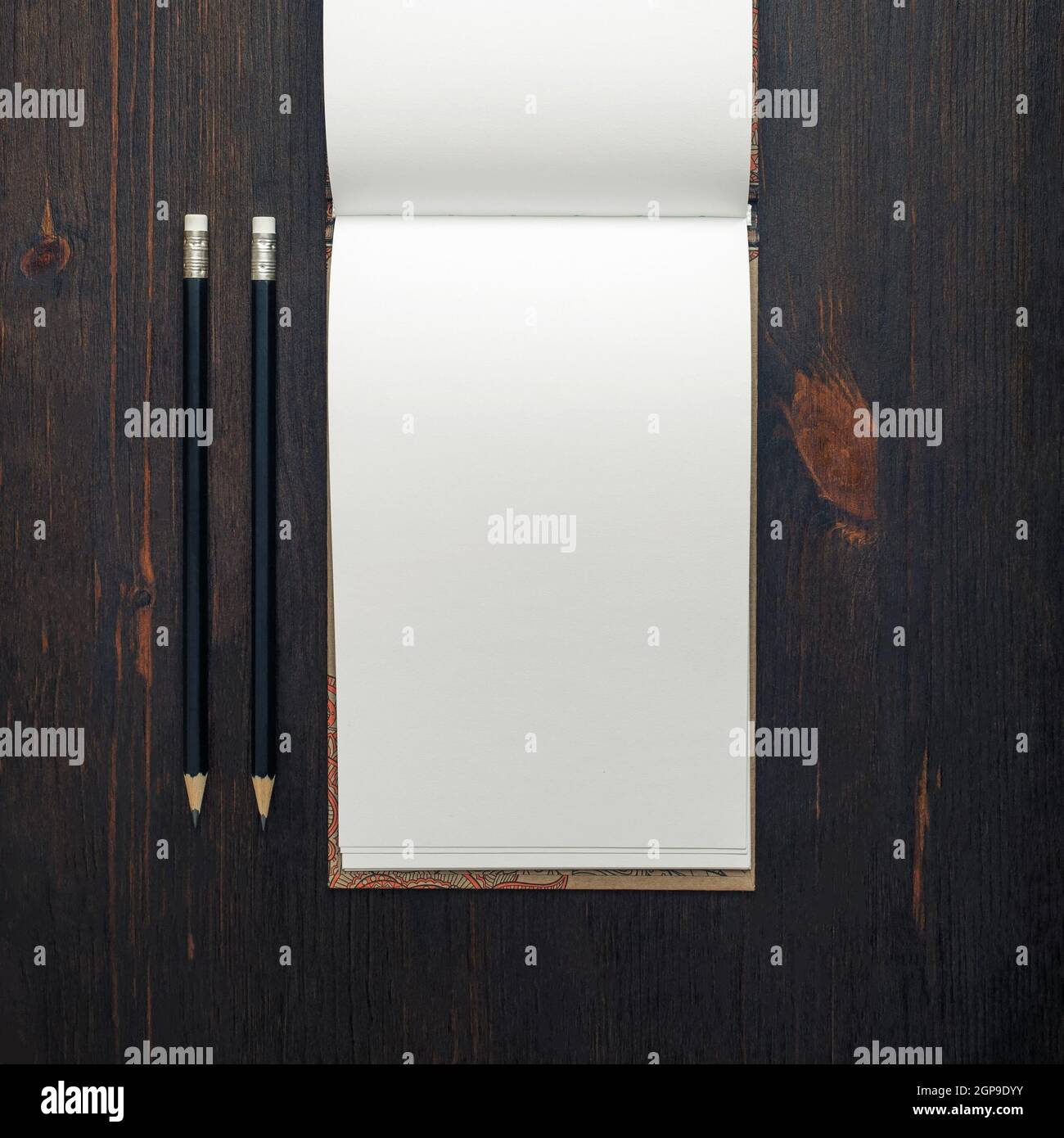 Blank open notebook or brochure and pencils on wood table background ...