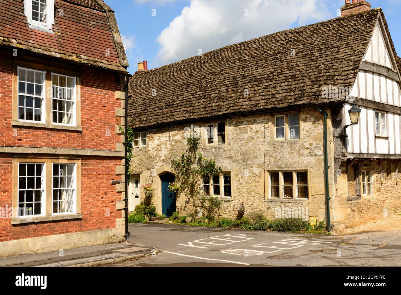 detail of medieval cottages built in brick, stone and wattle, prospecting on a street in historic touristic village of  Wiltshire Stock Photo