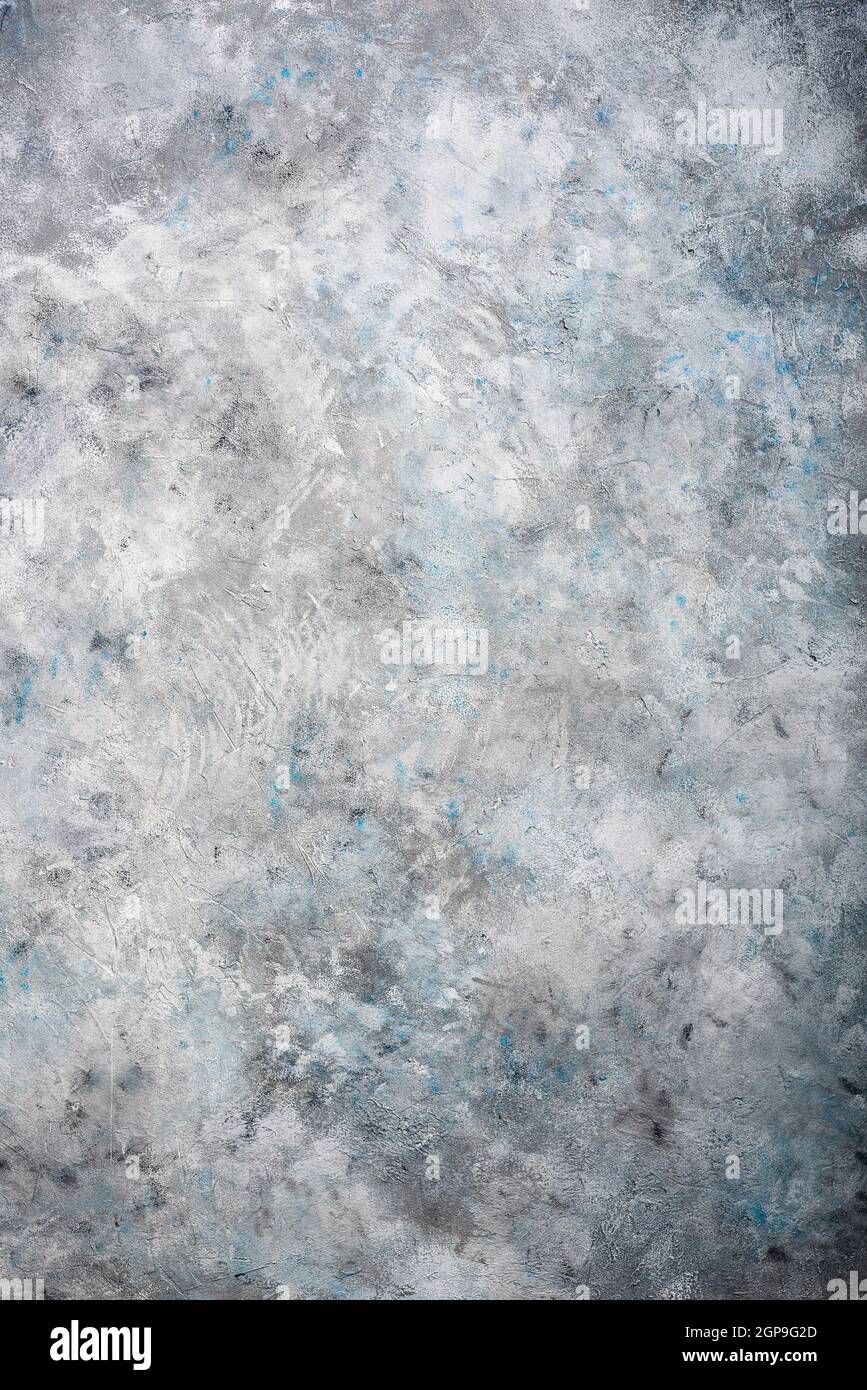 Gray textured concrete wall background with blue spots Stock Photo