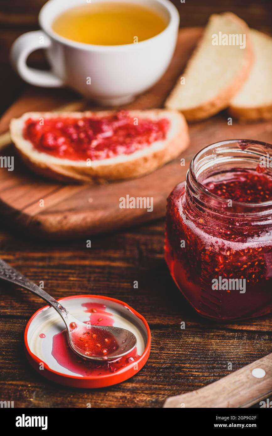 Toast with homemade raspberry jam with cup of green tea Stock Photo