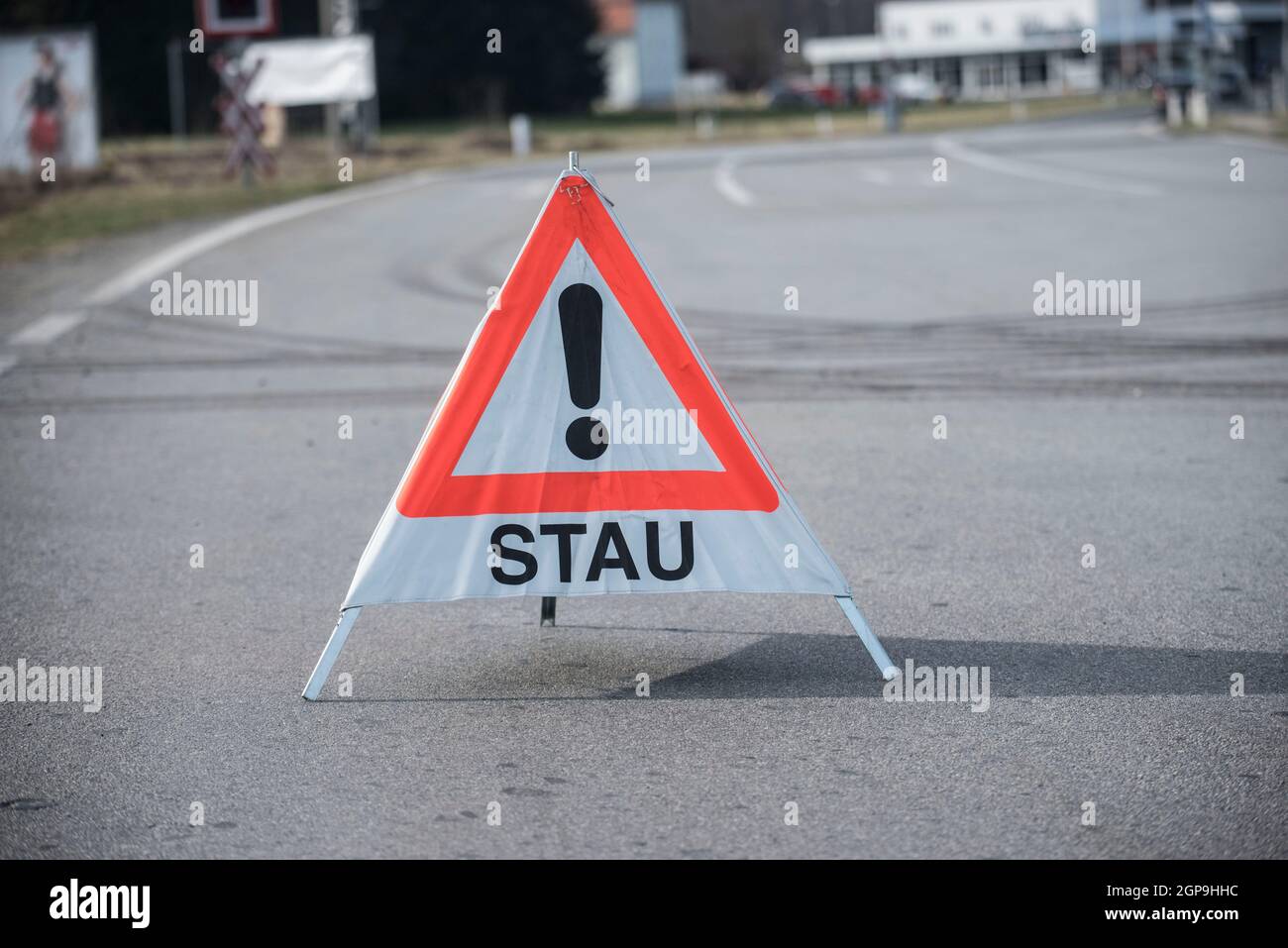 red and white warning triangle congestion (Stau) sign, standing on the road Stock Photo